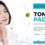Model applying a textured facial toning pad to her cheek next to water bubbles and centella asiatica leaves.